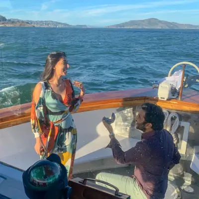 a couple of people that are standing in front of a body of water