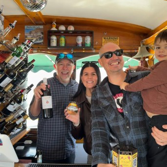 Family with child at the Wine Therapy bar aboard the 1958 wooden yacht on San Francisco Bay