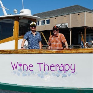 Wine Therapy owners Brian and Evan aboard the 1958 wooden yacht at Pier 39, San Francisco