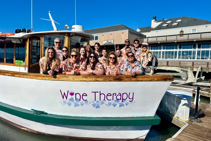 Private charter group in matching shirts aboard Wine Therapy at Pier 39, San Francisco