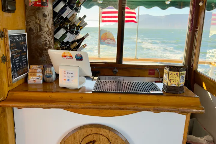 Wine Tasting on the Bay indoor bar with wine rack and panoramic views of San Francisco Bay